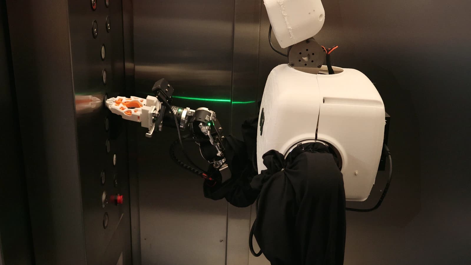 HALE 1.0 reaching toward controls inside an elevator